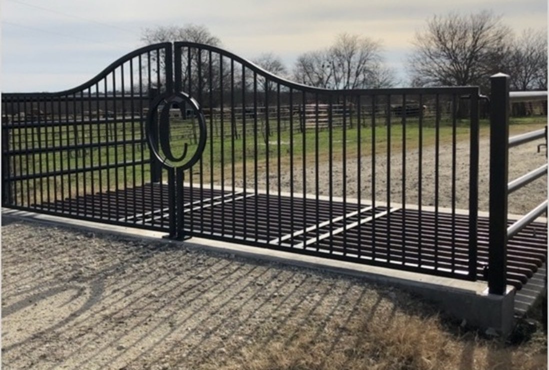 White Hog black steel ranch entrance gate with a custom brand medallion